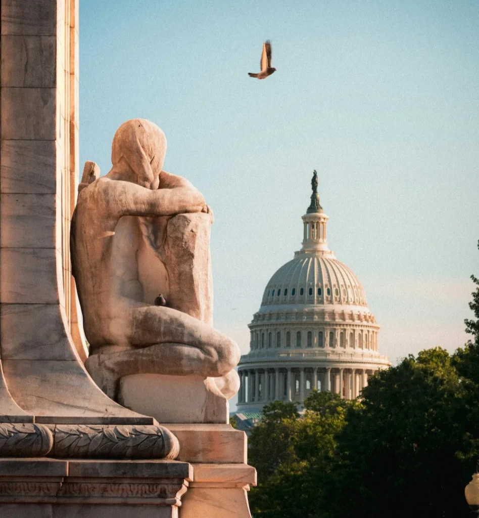 Marble statue at the U.S. Capitol with the Capitol dome in the background, Washington, D.C.