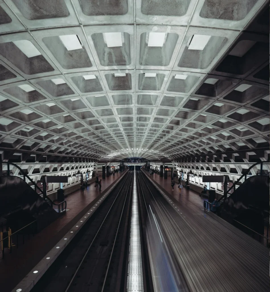 Interior of a Washington, D.C. Metro station showing train tracks and vaulted ceiling